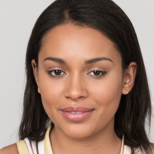 Joyful latino young-adult female with long  brown hair and brown eyes