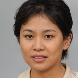 Joyful asian young-adult female with medium  brown hair and brown eyes