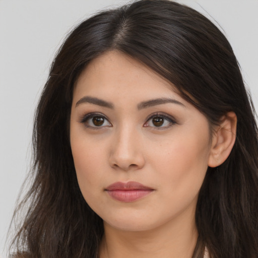 Joyful asian young-adult female with long  brown hair and brown eyes
