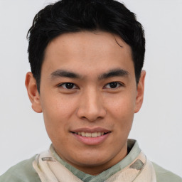 Joyful asian young-adult male with short  brown hair and brown eyes