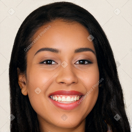 Joyful latino young-adult female with long  black hair and brown eyes