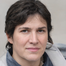 Joyful white adult female with medium  brown hair and grey eyes