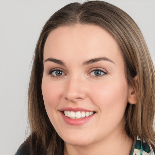 Joyful white young-adult female with long  brown hair and green eyes