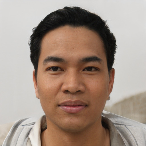 Joyful asian young-adult male with short  black hair and brown eyes