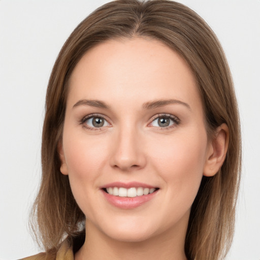 Joyful white young-adult female with long  brown hair and grey eyes