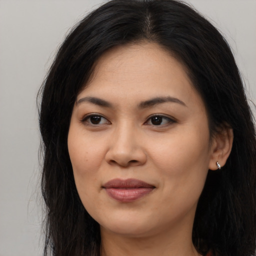 Joyful asian young-adult female with long  brown hair and brown eyes