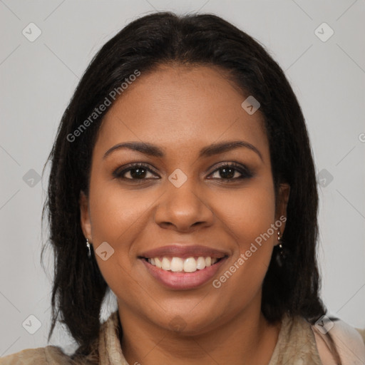 Joyful black young-adult female with long  brown hair and brown eyes