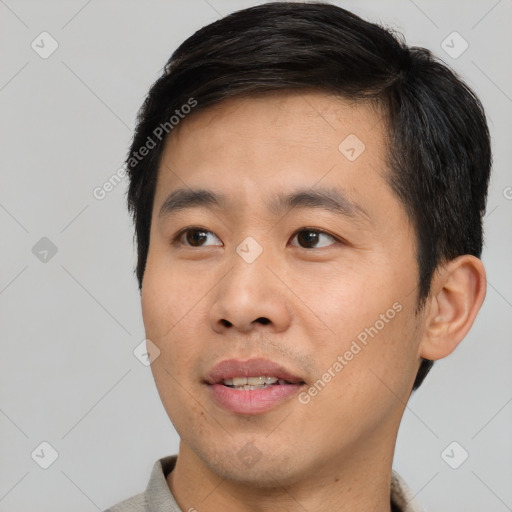 Joyful asian young-adult male with short  brown hair and brown eyes