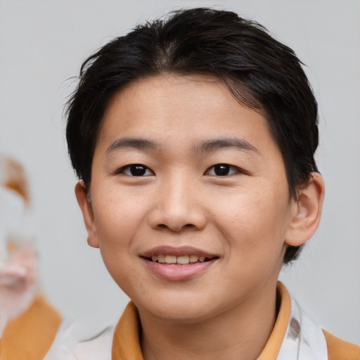Joyful asian young-adult female with short  brown hair and brown eyes