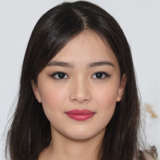 Joyful asian young-adult female with long  brown hair and brown eyes