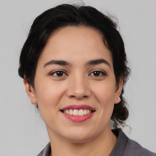 Joyful latino young-adult female with medium  brown hair and brown eyes