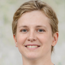 Joyful white young-adult female with medium  brown hair and green eyes