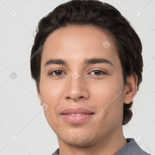 Joyful white young-adult male with short  black hair and brown eyes