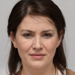 Joyful white adult female with medium  brown hair and brown eyes