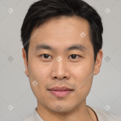 Joyful asian young-adult male with short  black hair and brown eyes