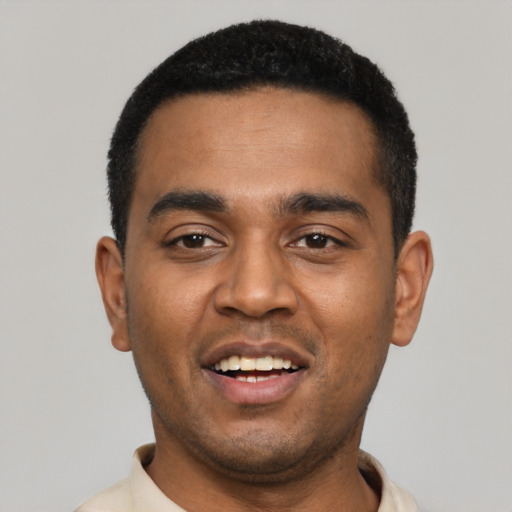 Joyful black young-adult male with short  black hair and brown eyes
