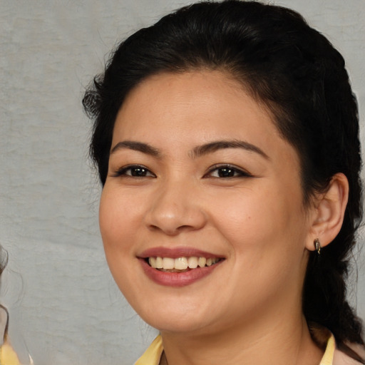 Joyful asian young-adult female with medium  brown hair and brown eyes