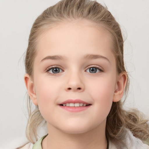 Joyful white child female with medium  brown hair and grey eyes