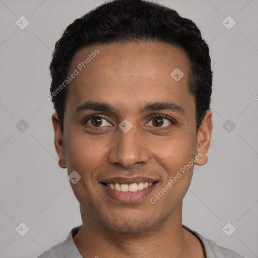 Joyful latino young-adult male with short  black hair and brown eyes