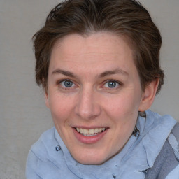 Joyful white adult female with medium  brown hair and blue eyes