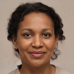 Joyful black adult female with medium  brown hair and brown eyes