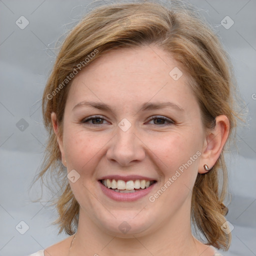 Joyful white young-adult female with medium  brown hair and blue eyes