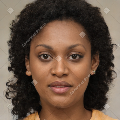 Joyful black young-adult female with long  brown hair and brown eyes