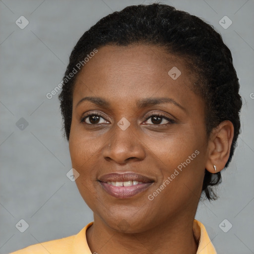 Joyful black young-adult female with short  brown hair and brown eyes