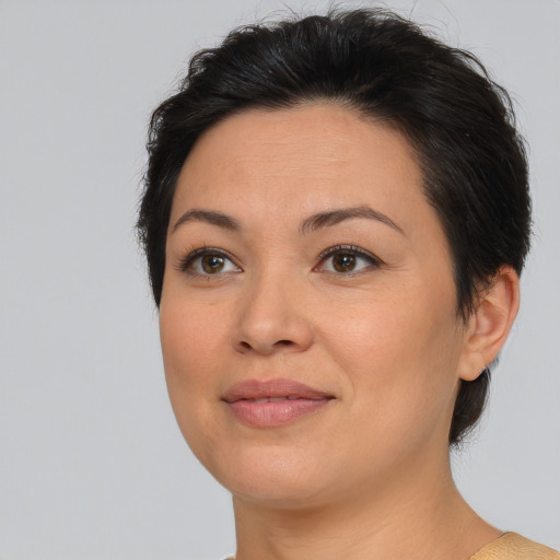 Joyful asian adult female with medium  brown hair and brown eyes