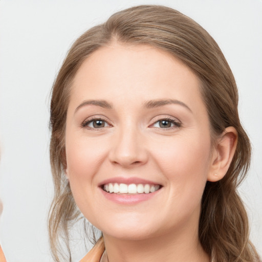 Joyful white young-adult female with long  brown hair and grey eyes