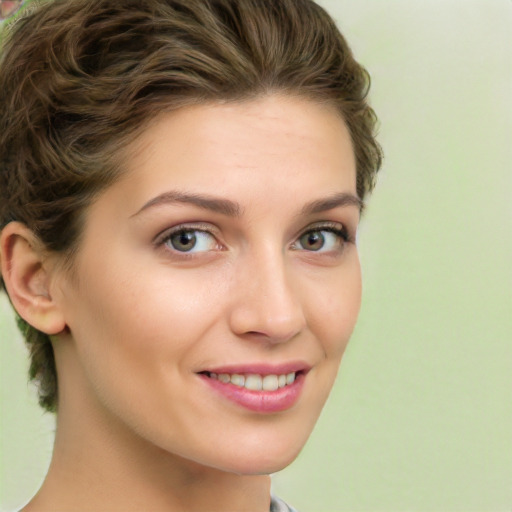 Joyful white young-adult female with short  brown hair and green eyes