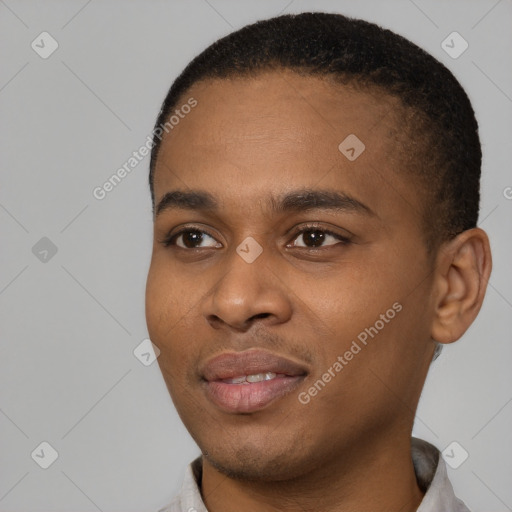 Joyful black young-adult male with short  black hair and brown eyes