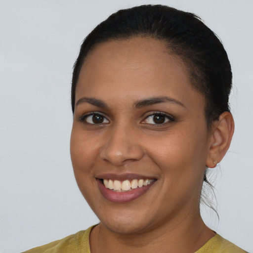 Joyful latino young-adult female with short  black hair and brown eyes