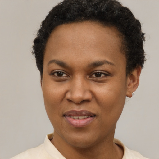 Joyful black young-adult female with short  brown hair and brown eyes