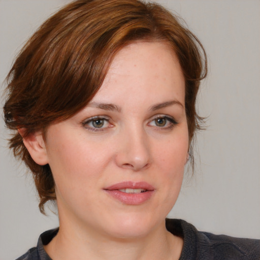 Joyful white young-adult female with medium  brown hair and blue eyes