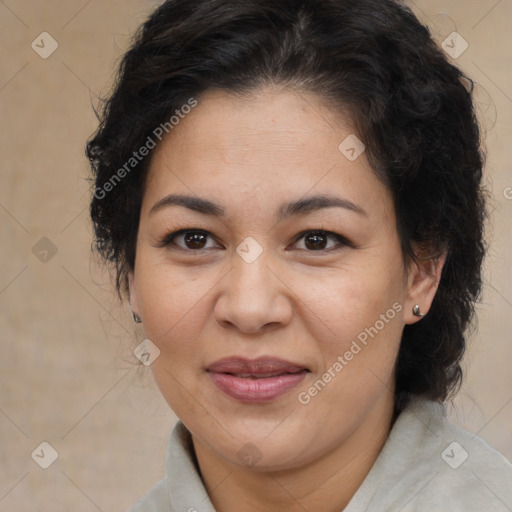 Joyful latino adult female with medium  brown hair and brown eyes