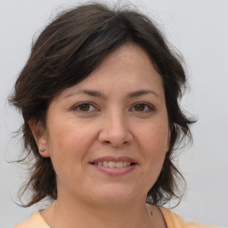 Joyful white adult female with medium  brown hair and brown eyes