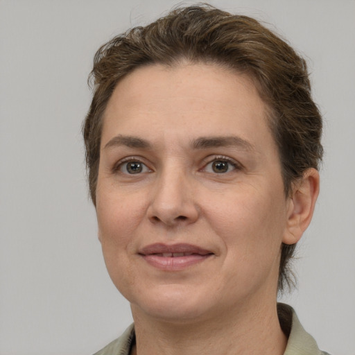 Joyful white adult female with short  brown hair and grey eyes