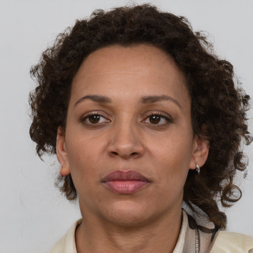 Joyful black adult female with medium  brown hair and brown eyes