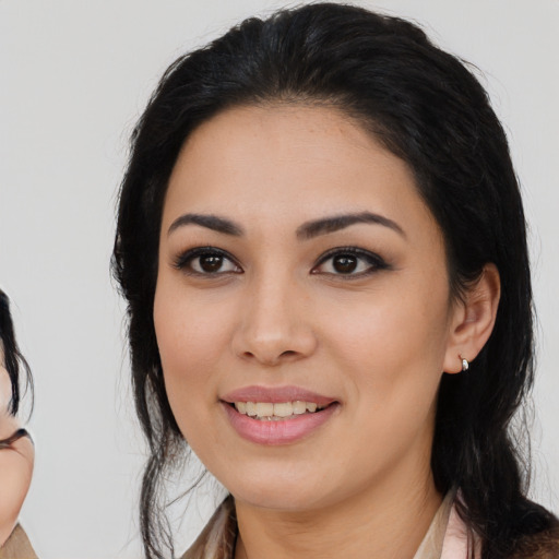 Joyful white young-adult female with medium  black hair and brown eyes
