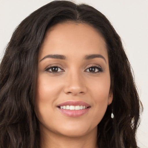 Joyful white young-adult female with long  brown hair and brown eyes