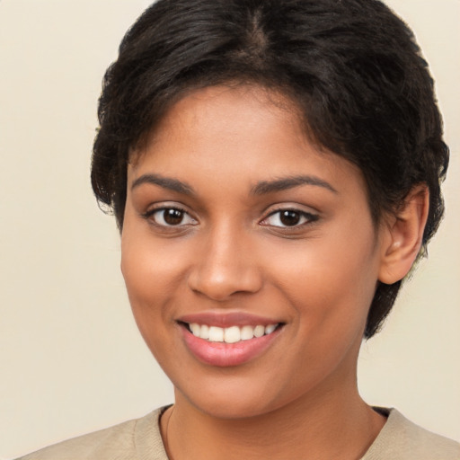 Joyful latino young-adult female with short  brown hair and brown eyes