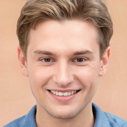 Joyful white young-adult male with short  brown hair and grey eyes