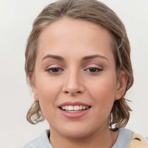 Joyful white young-adult female with medium  brown hair and grey eyes