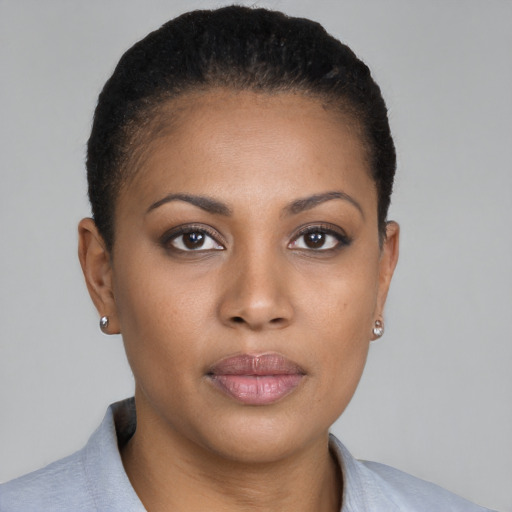 Joyful black young-adult female with short  brown hair and brown eyes