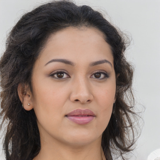 Joyful latino young-adult female with long  brown hair and brown eyes