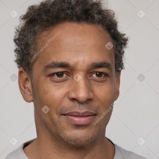 Joyful latino adult male with short  brown hair and brown eyes