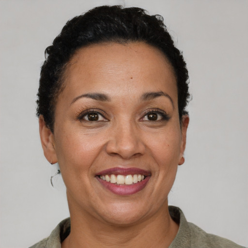 Joyful black adult female with short  brown hair and brown eyes
