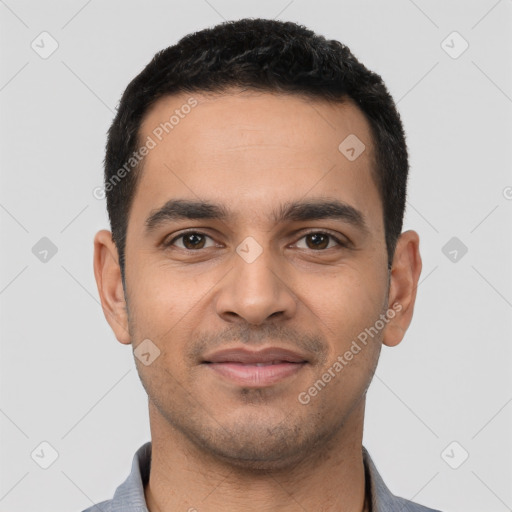 Joyful latino young-adult male with short  black hair and brown eyes