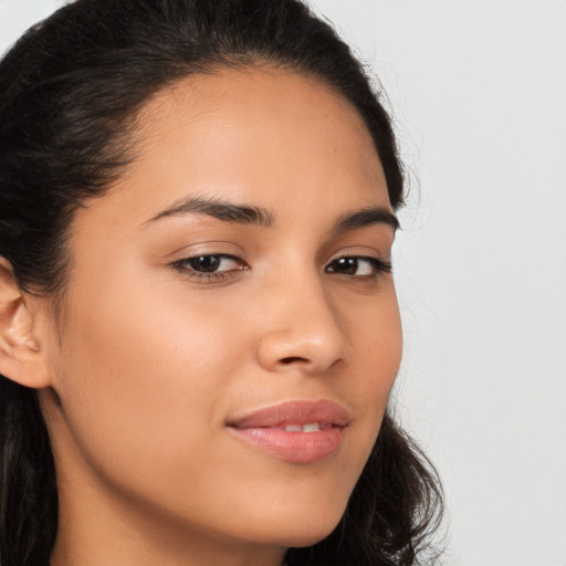 Joyful latino young-adult female with long  brown hair and brown eyes